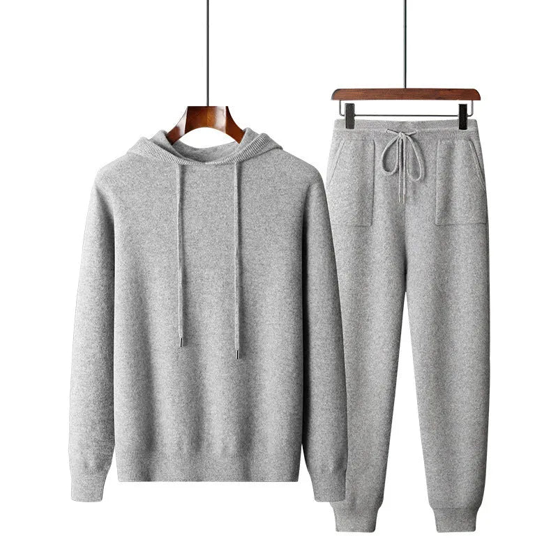 Men's dark grey cashmere hooded sweatshirt and matching long pants laid flat as a complete set.