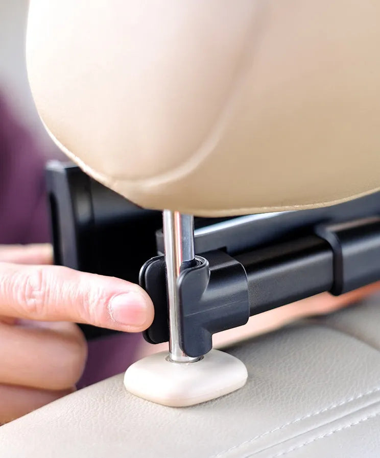 Black universal car phone holder mounted on vehicle rear seat with tablet in snap-in mechanism