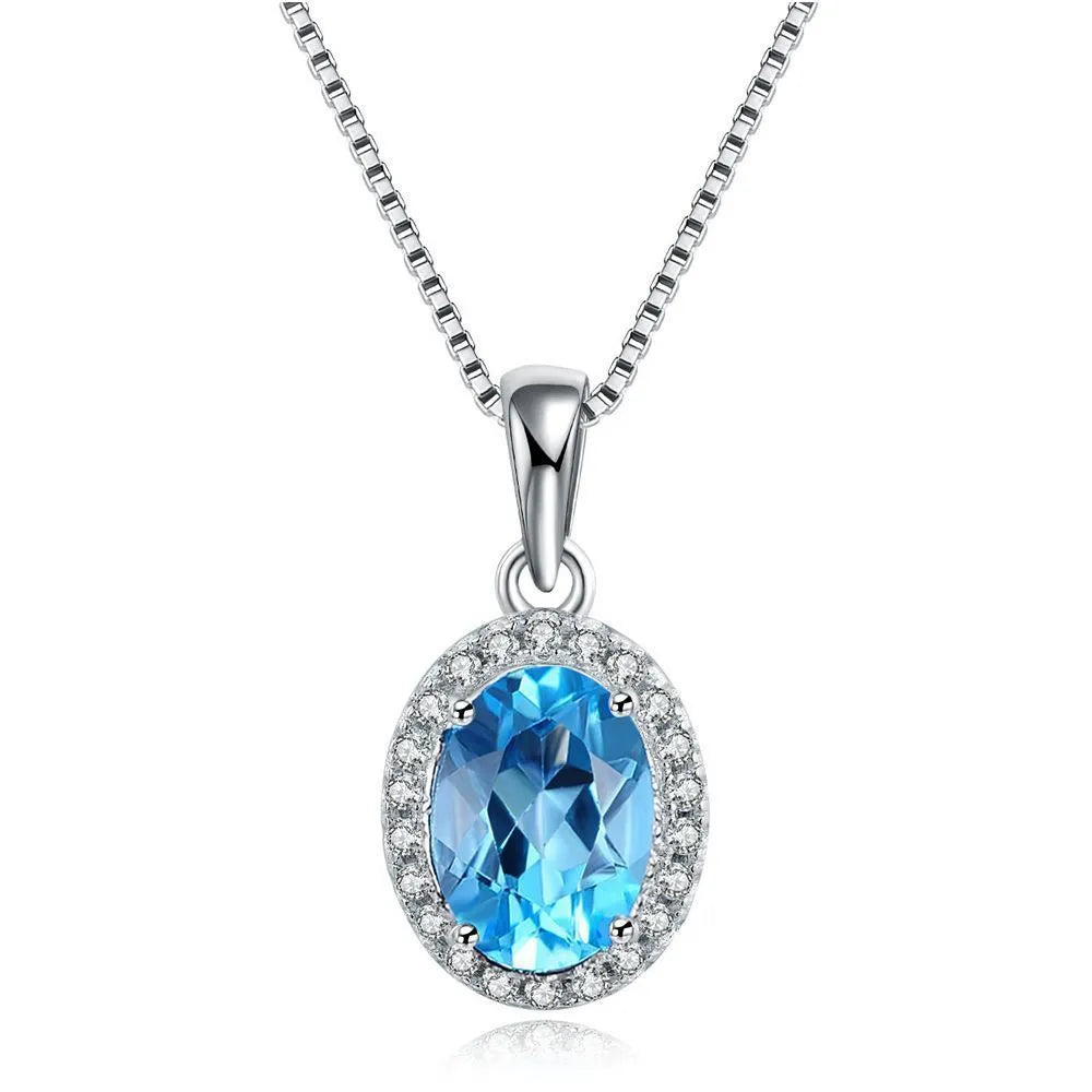 925 sterling silver jewellery set with blue topaz stones showing earrings, ring, pendant, and necklace with chain in geometric design