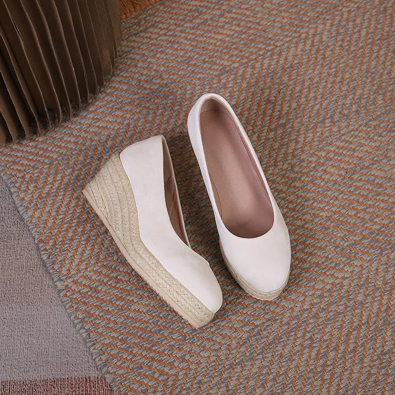 Women's apricot wedge heel pumps with round toe and shallow mouth design on a white background.
