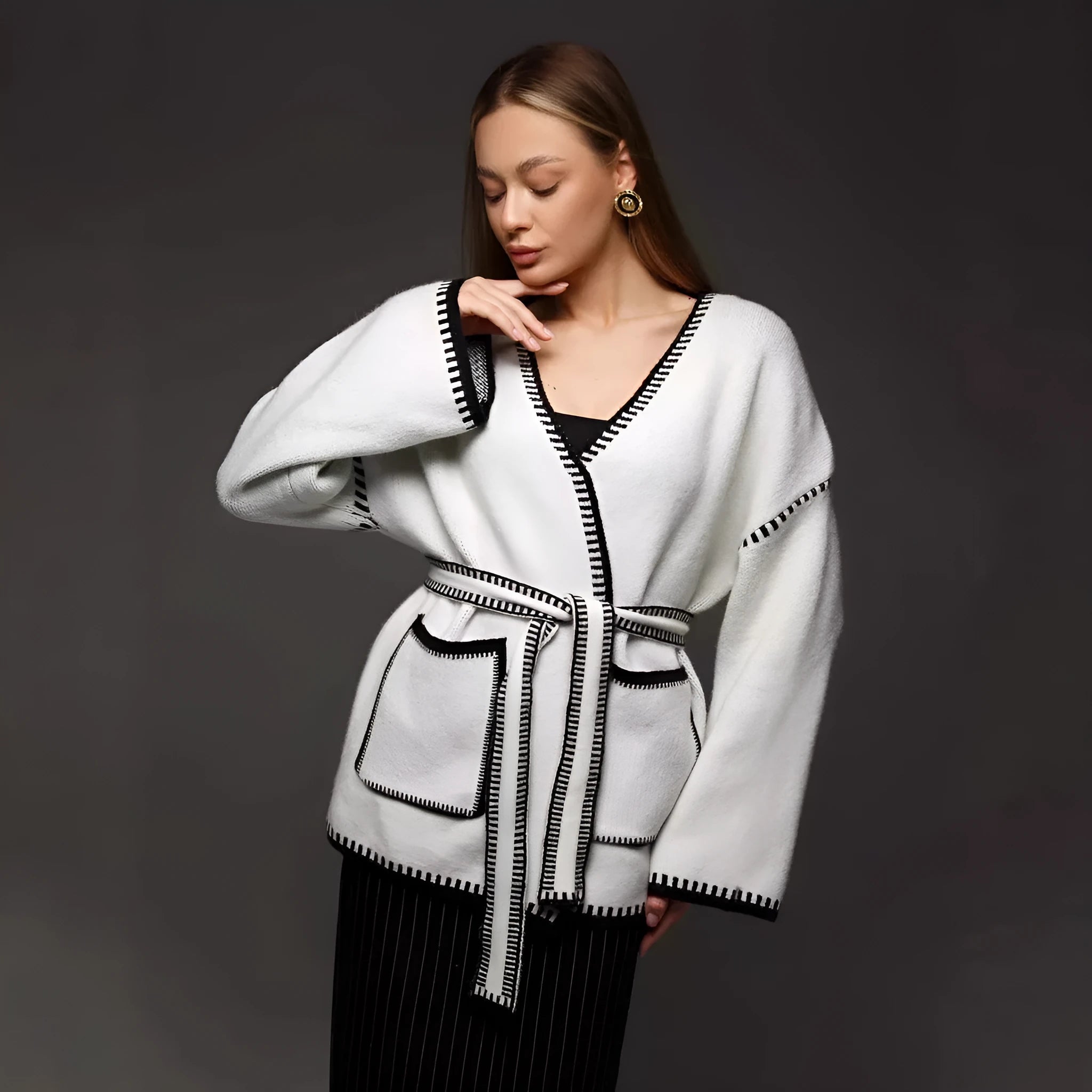 Loose lace-up front knitted cardigan in camel colour, showing mid-length fit and long sleeves.