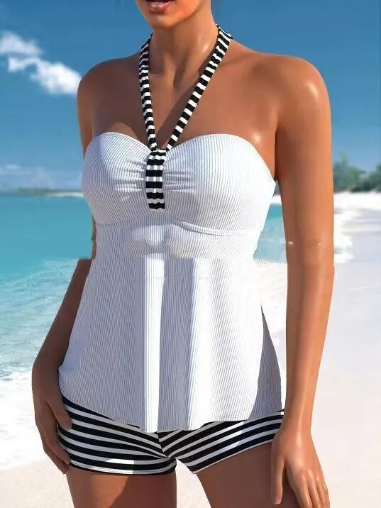 Women's black and white striped off-shoulder one-piece swimsuit on a mannequin.