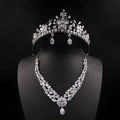 Three piece bridal jewellery set with gold leaf crown necklace and earrings on white background