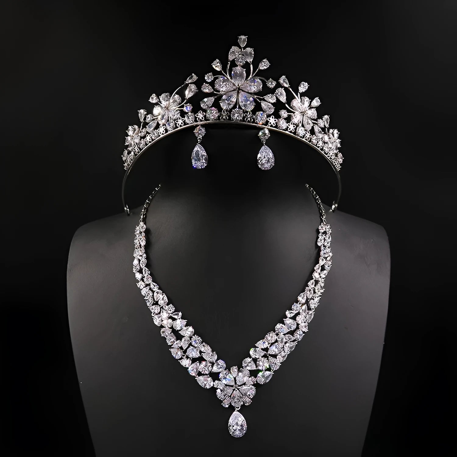 Three piece bridal jewellery set with gold leaf crown necklace and earrings on white background
