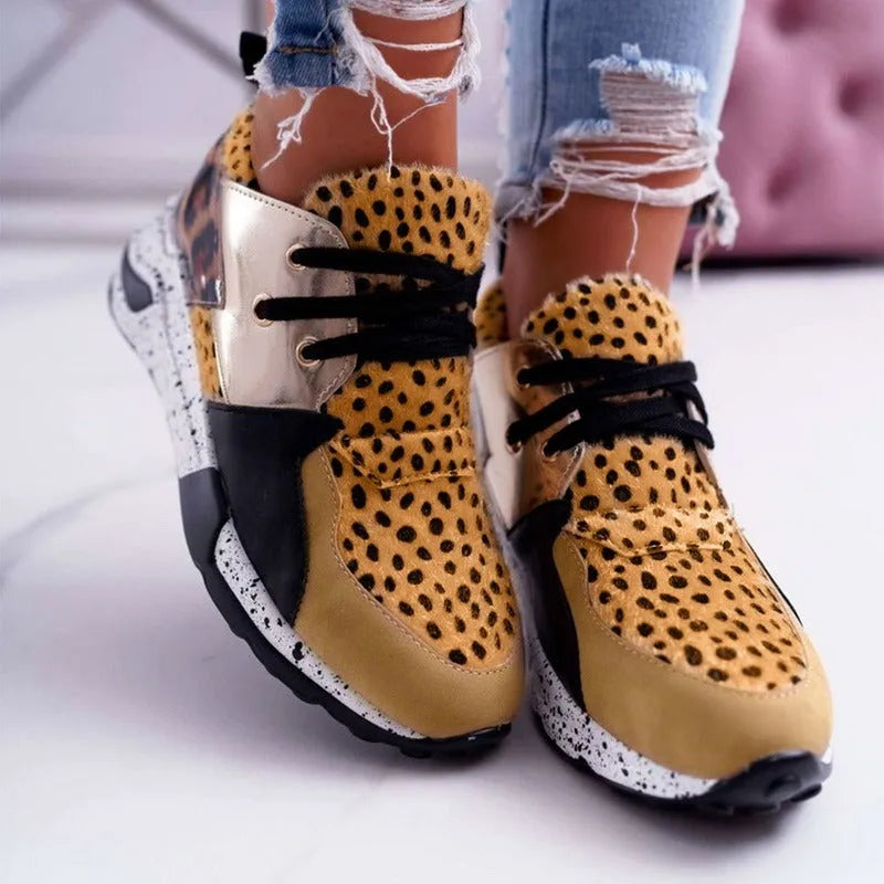 Women's suede flat sneakers with a wedge heel in leopard print, shown from the side.