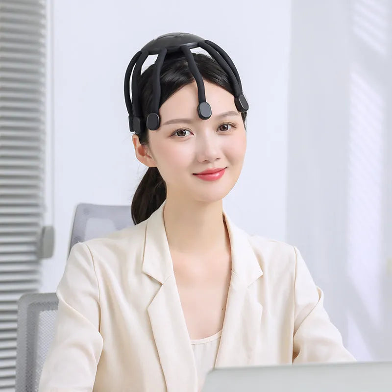 Black USB-powered electric head massager with multiple vibrating claws on scalp