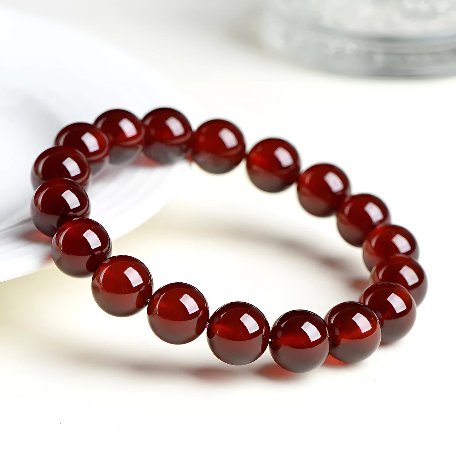 Natural orange red garnet crystal ball bracelet with ruyi charm detail in retro unisex style
