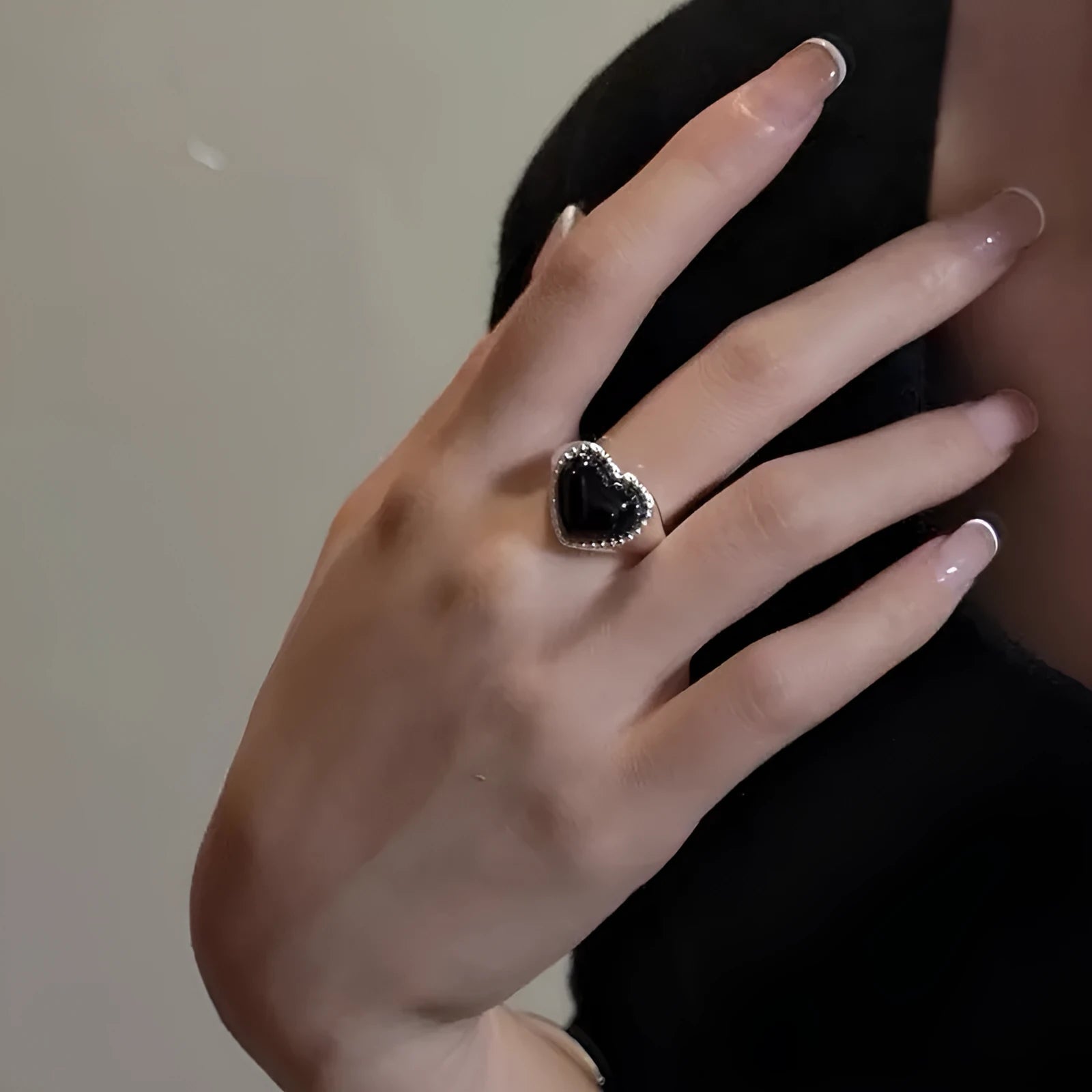 S925 sterling silver ring with black agate heart on adjustable open band.