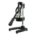 Black cast iron manual citrus juicer with stainless steel cone and lever, 40cm tall on a table.