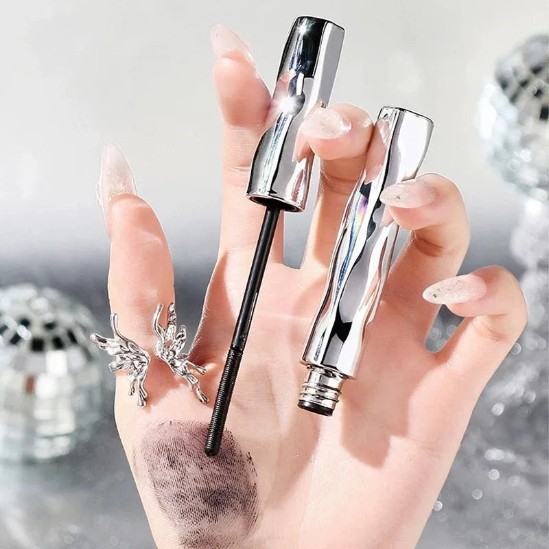 Waterproof black and brown steel tube mascara with optional eyelash curler accessory.