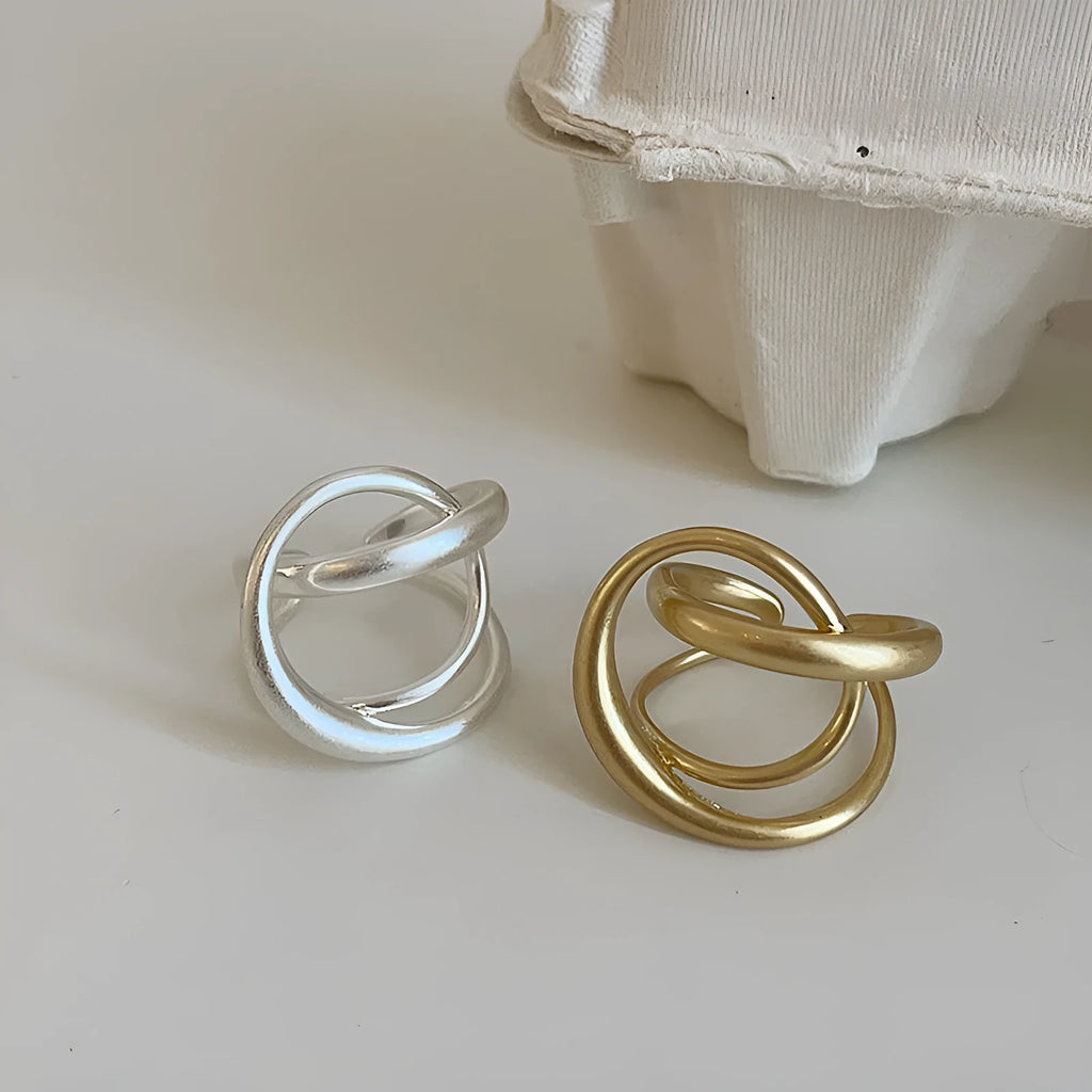 Three-dimensional interlaced geometric open ring in matte metal with gold electroplating