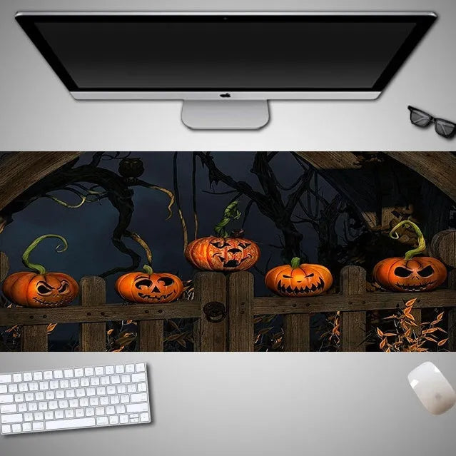 Oversized Halloween-themed rubber cloth mouse pad on a desk, showing non-slip base and large surface area.