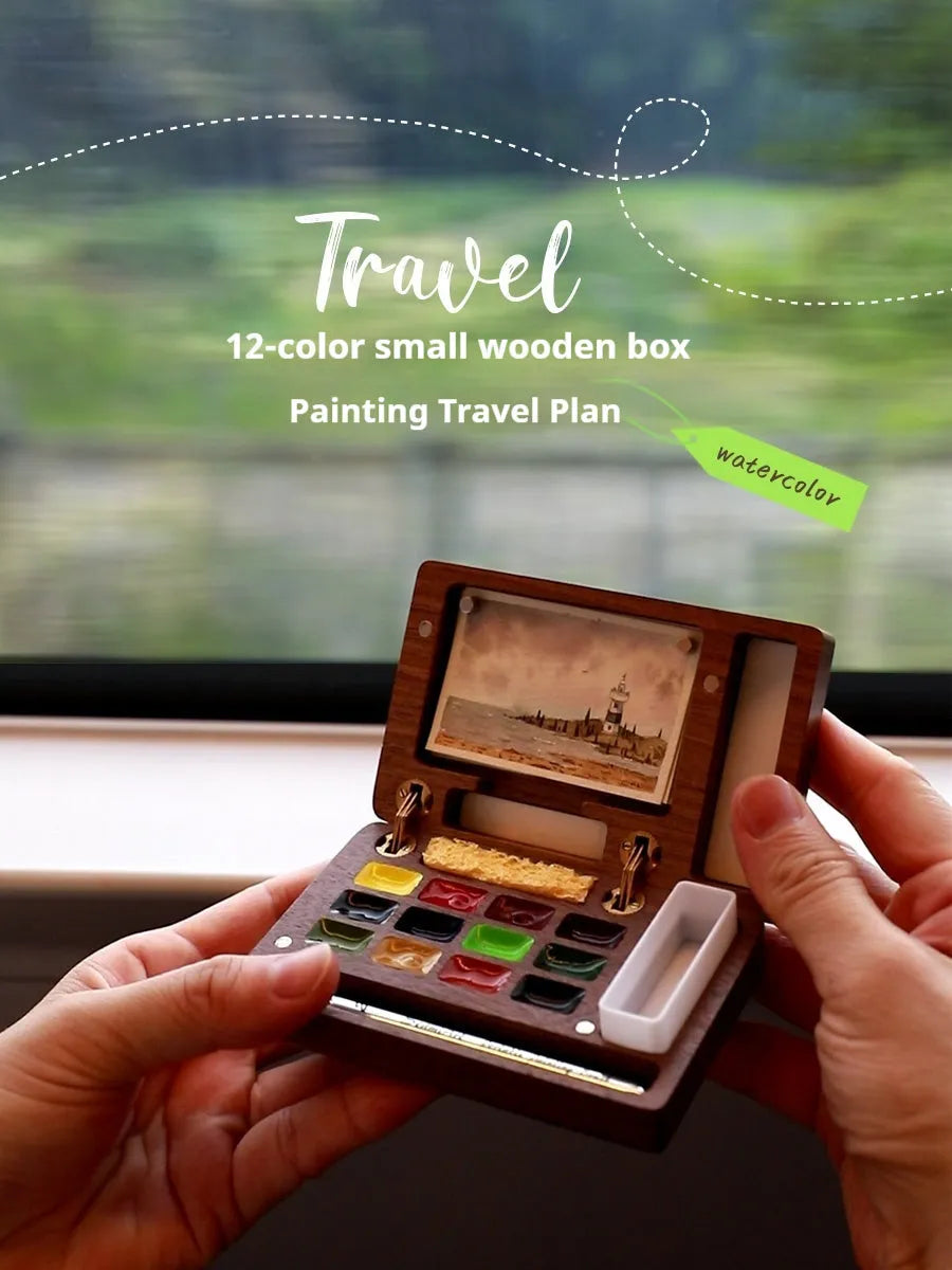 Mini walnut wood watercolour paint box open to show paint pans, with Holbein and Schminke pigment suit options.