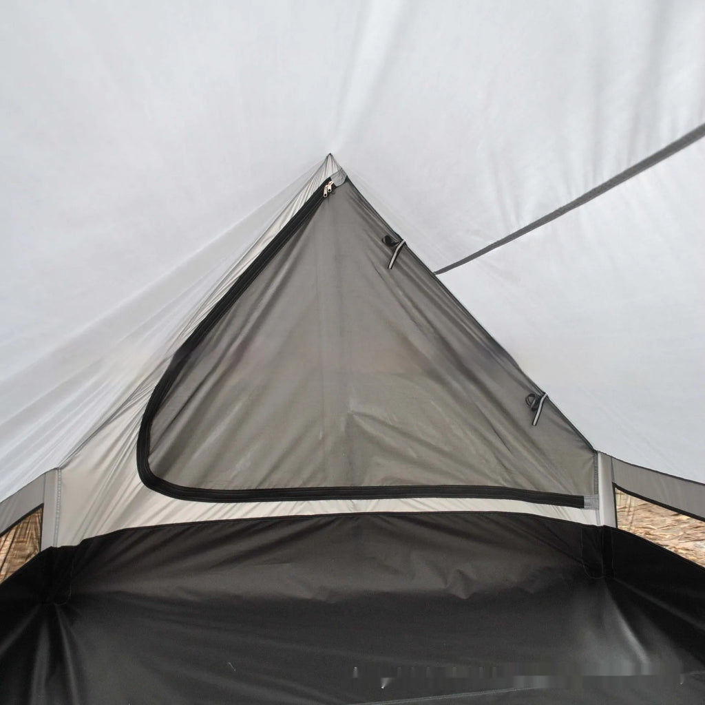 Brown A-line cabin tent pitched using hiking poles with aluminium ground nails and fluorescent wind ropes
