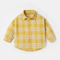 A boys' casual cotton lattice shirt with long sleeves, shown in one of four colours: khaki, light blue, pink, or yellow, featuring an animal or cartoon pattern.
