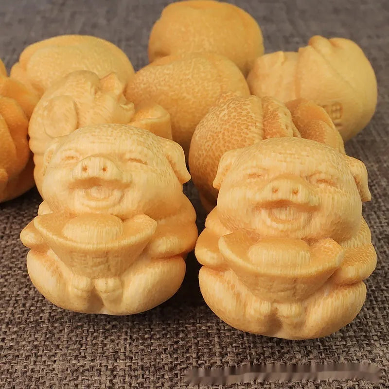 Solid bamboo carving ornament of a cute ingot pig, 4cm tall by 3.5cm diameter.