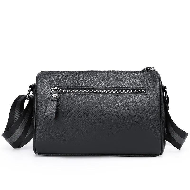 Black genuine leather crossbody bag showing single shoulder strap and structured 24x16x13cm design.