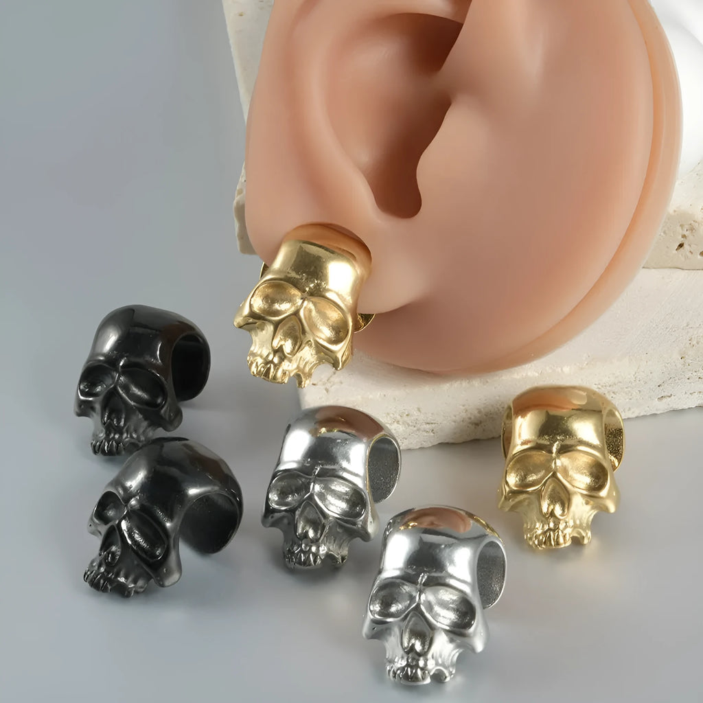 Stainless steel hollow skull Buddha earring for auricle piercing in hip hop style.