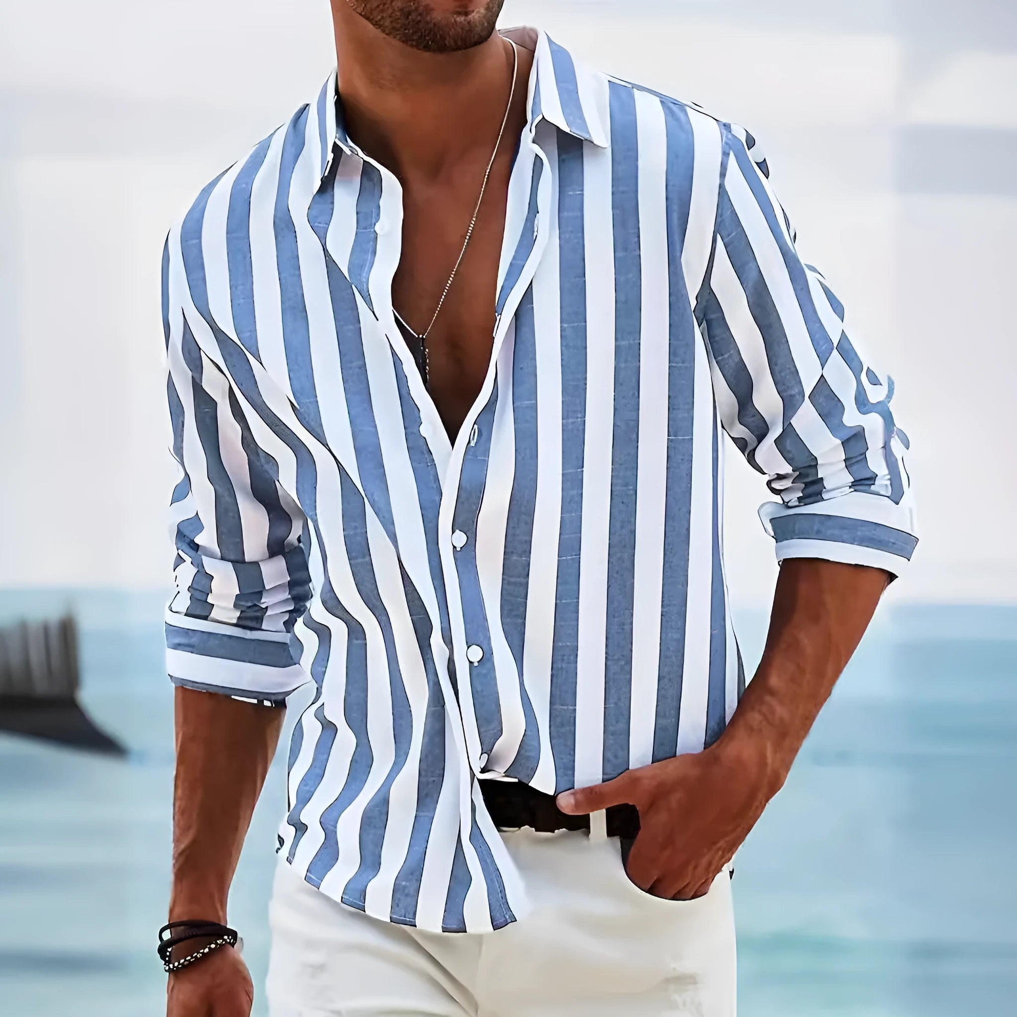 Man wearing a loose grey striped casual long-sleeved shirt with a cardigan style.
