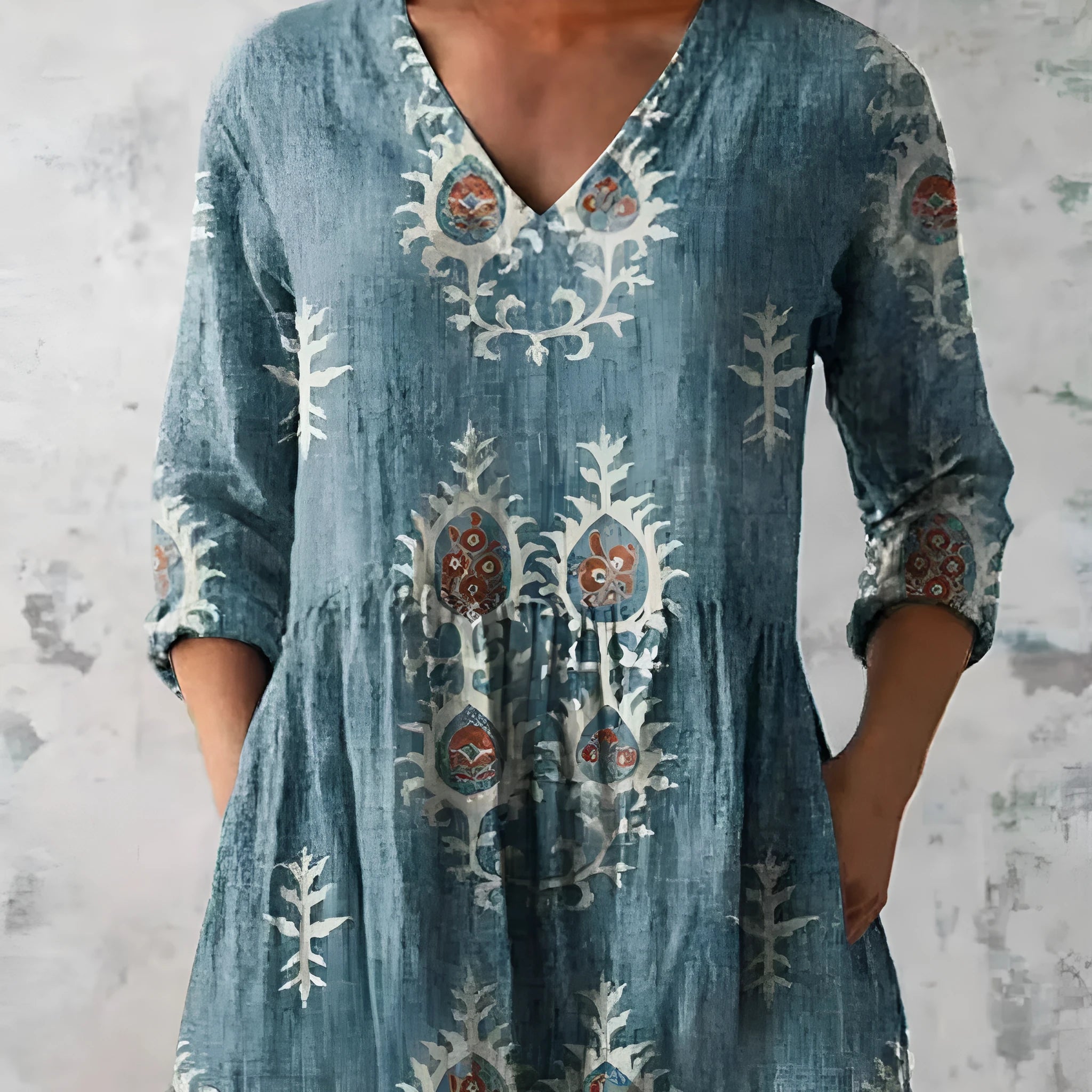 A woman wearing a loose, printed dress with 3/4 sleeves and a wide waist, available in multiple sizes.