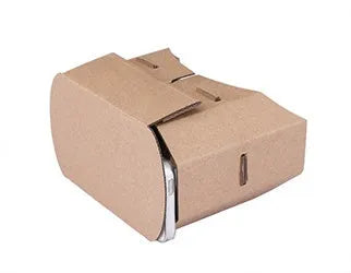 Corrugated paper virtual reality glasses headset for smartphones on a table.