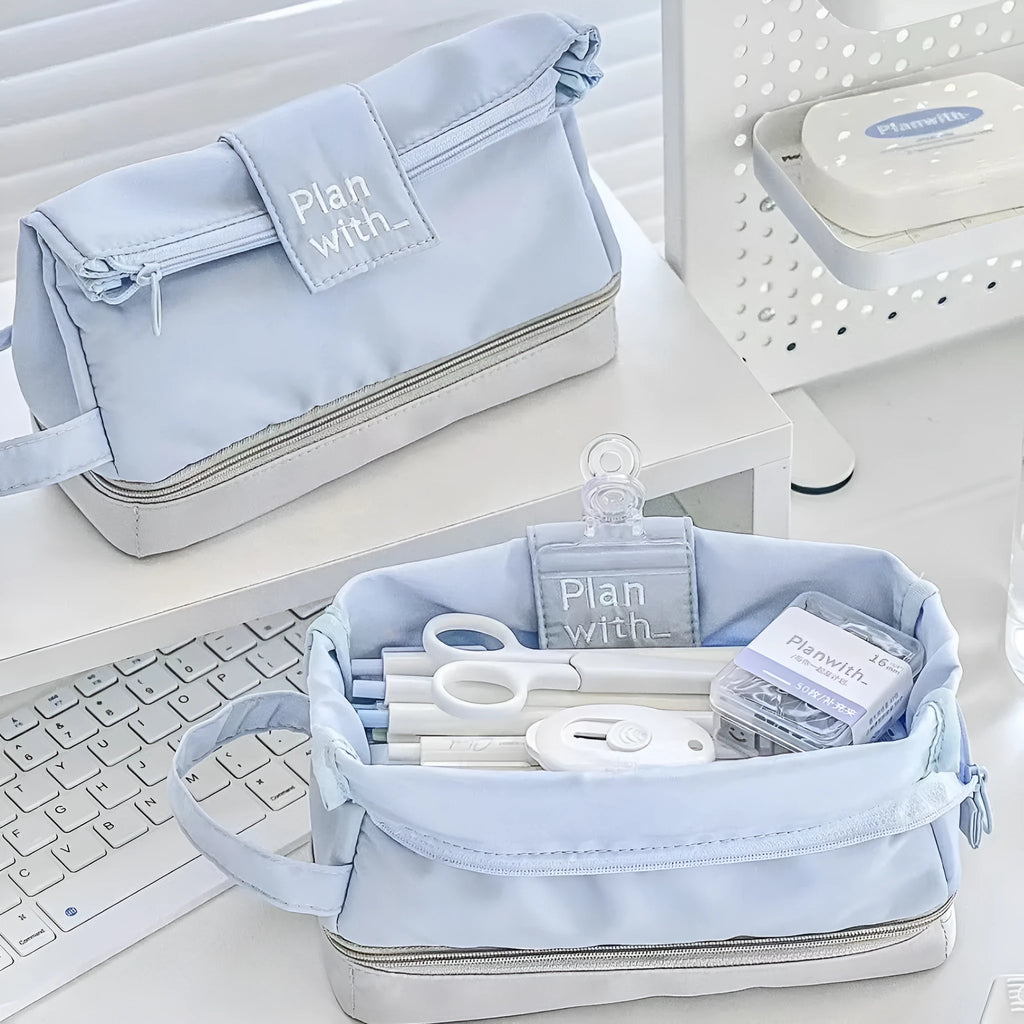 Folding double layer student pencil case in blue, navy blue, and cream white colours made from polyester fabric.