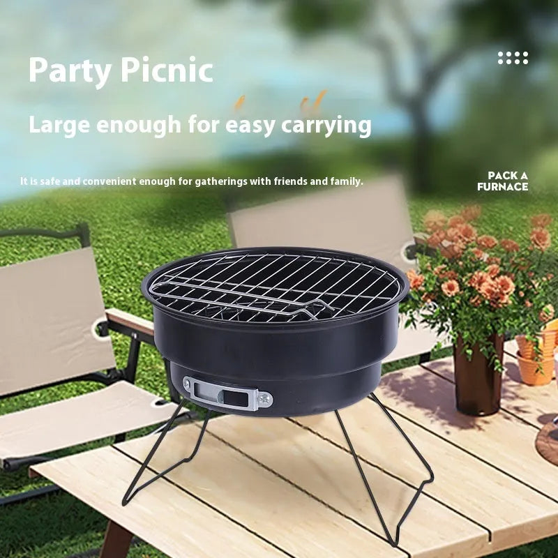 Small round metal folding camping stove with grill mesh and legs, packed in a carry bag.