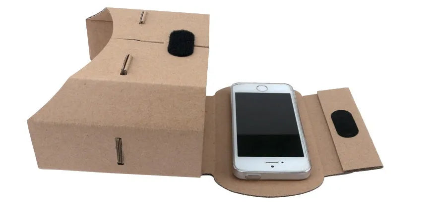 Corrugated paper virtual reality glasses headset for smartphones on a table.