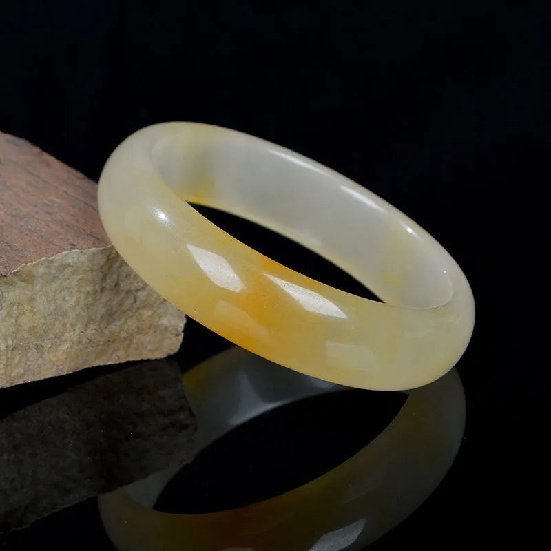 Natural gem light jade bracelet in Chinese style with polished surface showing traditional ornament form