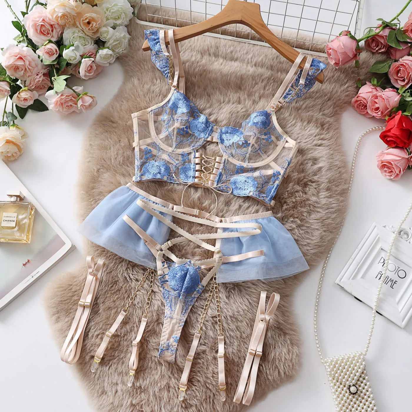 Light blue embroidered lace women's bra and panty set with transparent push up design and mesh detail.