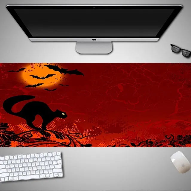 Oversized Halloween-themed rubber cloth mouse pad on a desk, showing non-slip base and large surface area.
