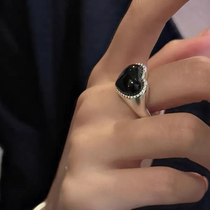 S925 sterling silver ring with black agate heart on adjustable open band.