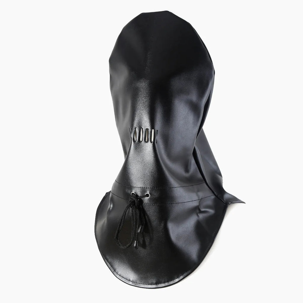 Black leather adult training mask headgear prop on a plain background