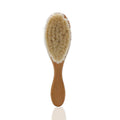 Beech wood baby shampoo brush with goat wool bristles in primary colour finish.