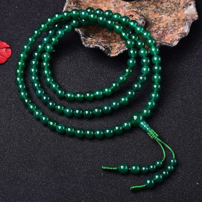 Handmade natural green agate Thangka pendant multi-circle bracelet on wrist.