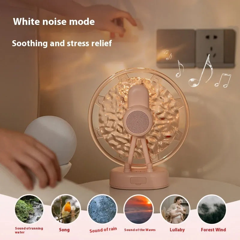 Pink Ferris wheel Bluetooth speaker projecting colourful water ripple light patterns on a surface.