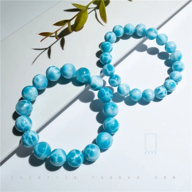 Unisex blue pearl and natural crystal sea-pattern stone bodhi bracelet on a wrist, showing Maillard style design.