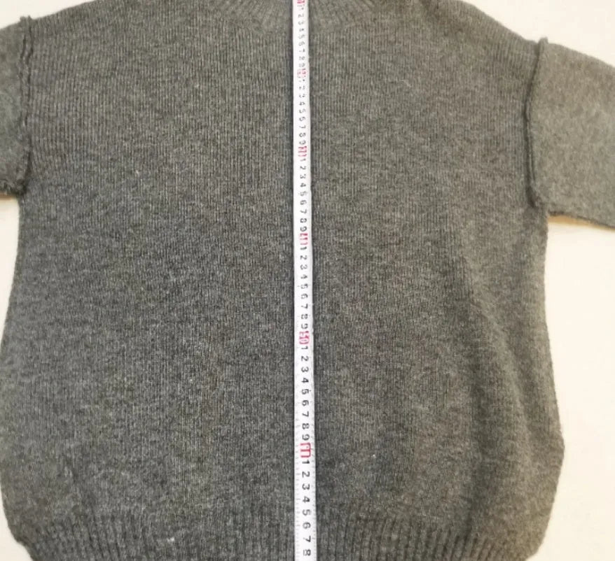 Women's acrylic sweater suit with side-slit top and trousers in dark grey.