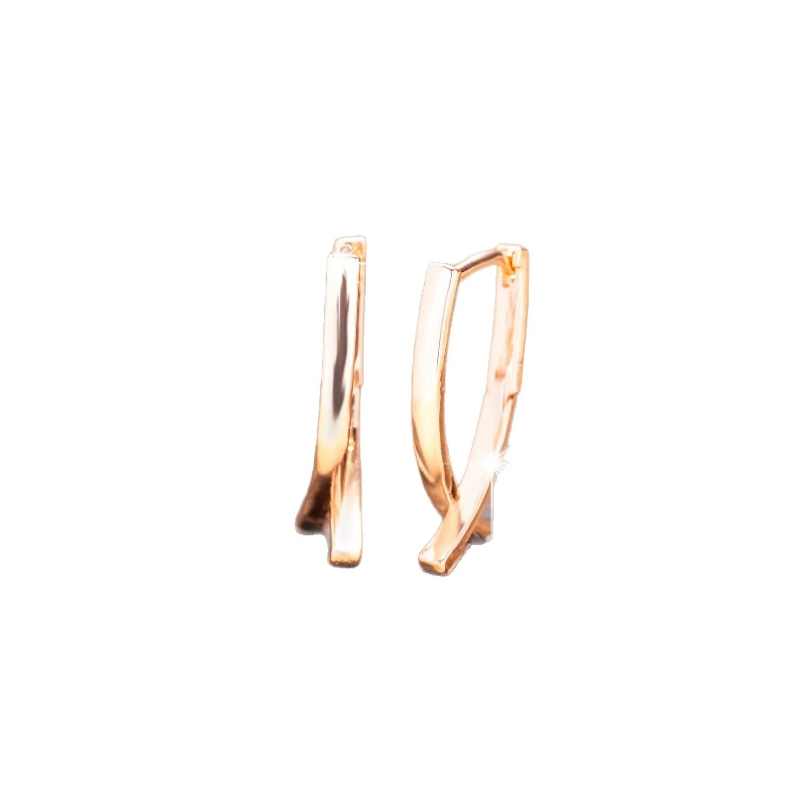 Rose gold coloured cross-shaped drop earrings for women on a white background.