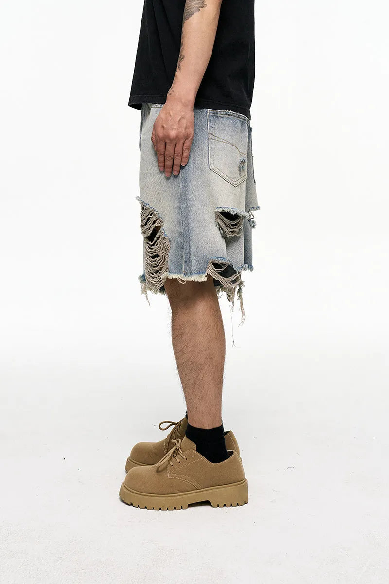 Men's light blue baggy denim shorts with a mid-rise waist and wide leg fit.
