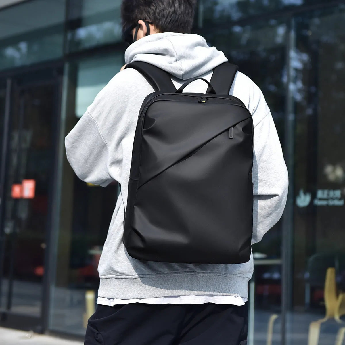 Large black waterproof PU leather backpack with sewing thread detailing