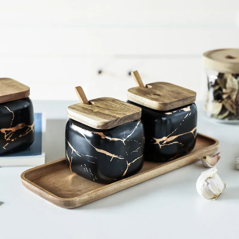 Nordic gold marble ceramic jar set with wooden tray and bamboo spoon on a kitchen counter