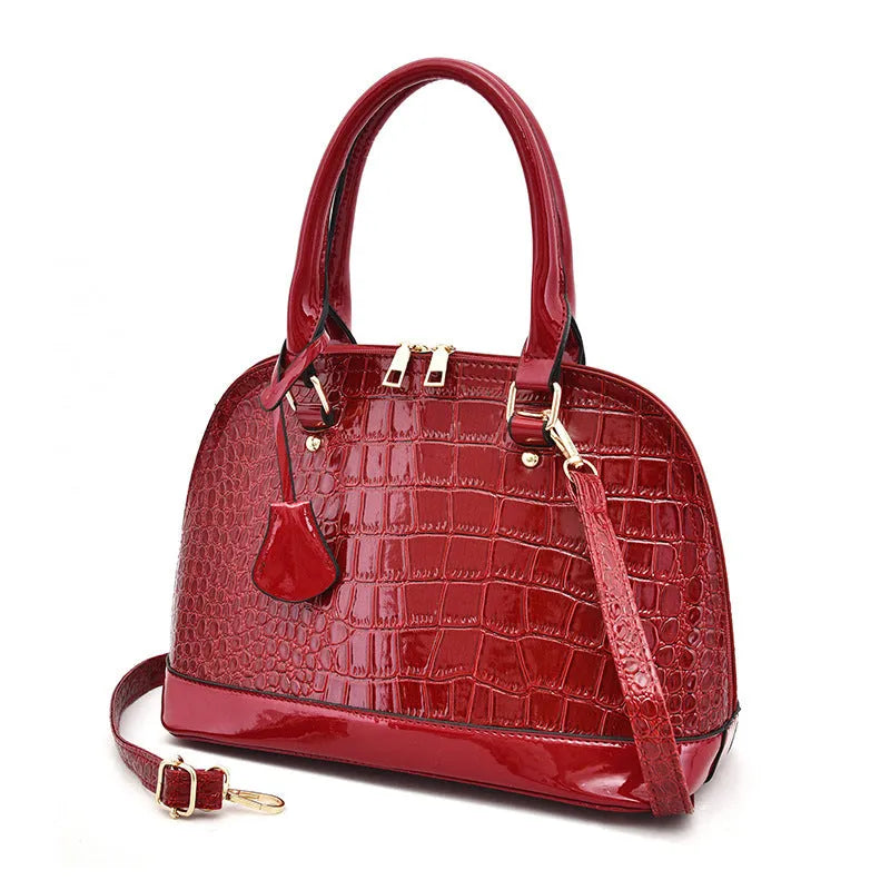 Large shiny black PU leather crossbody shoulder bag with a shell shape.