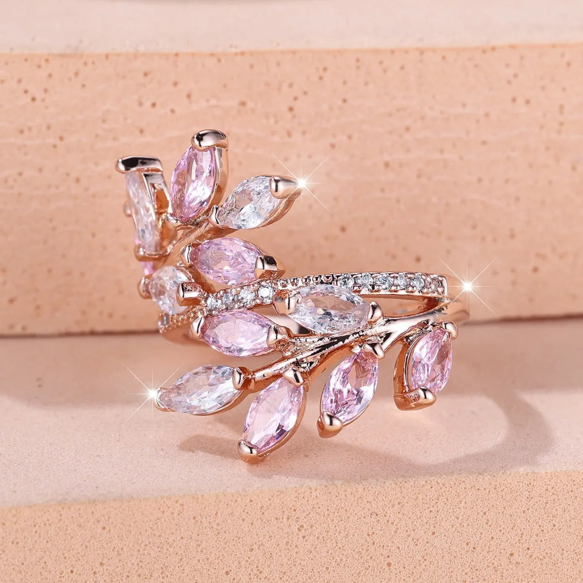 Adjustable horse eye design leaf ring in copper with zircon crystals, shown in a rose gold finish