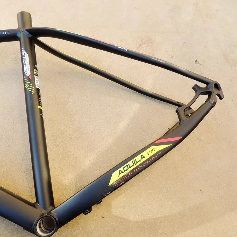 Black green 29-inch aluminium mountain bike frame with internal cable routing and disc brake mounts.