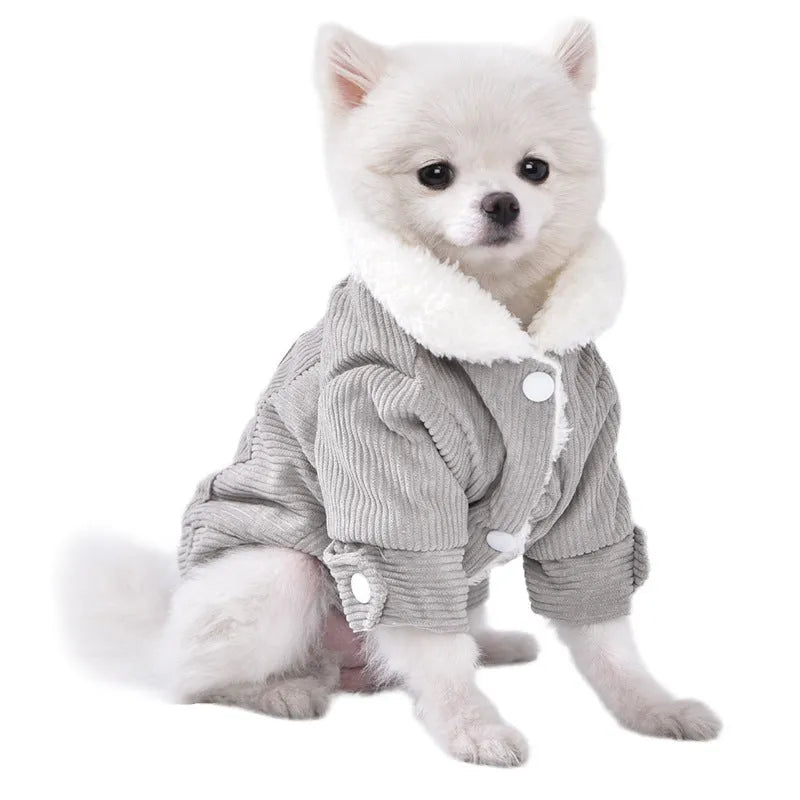 A grey lambswool fleece-lined vest for dogs on a hanger, showing its soft lining and size label.
