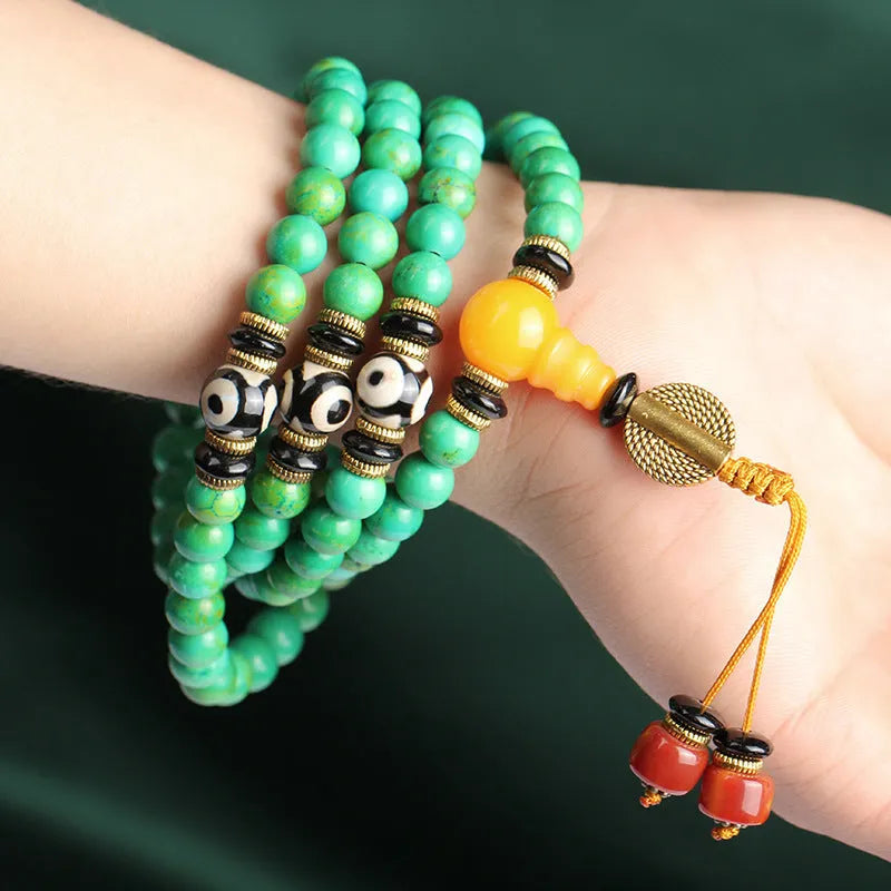 Natural turquoise bracelet with 108 round 8mm beads on a white background