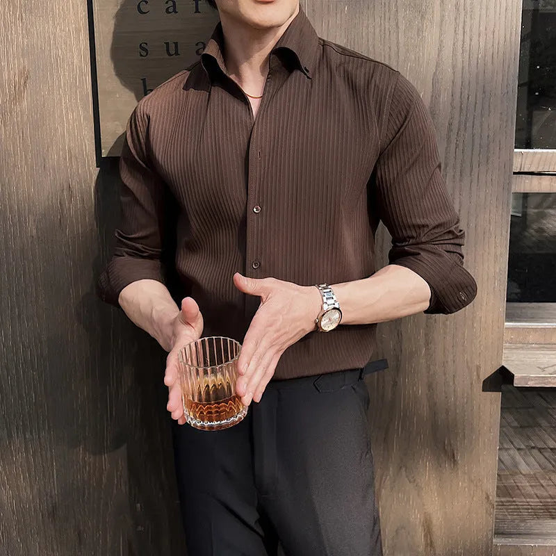 Man wearing a dark striped V-neck long sleeve casual shirt in a cardigan style.