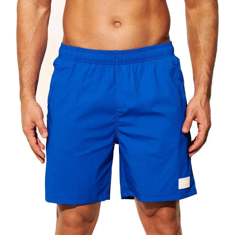 Men's quick-drying nylon sports shorts in solid colours with straight leg opening.
