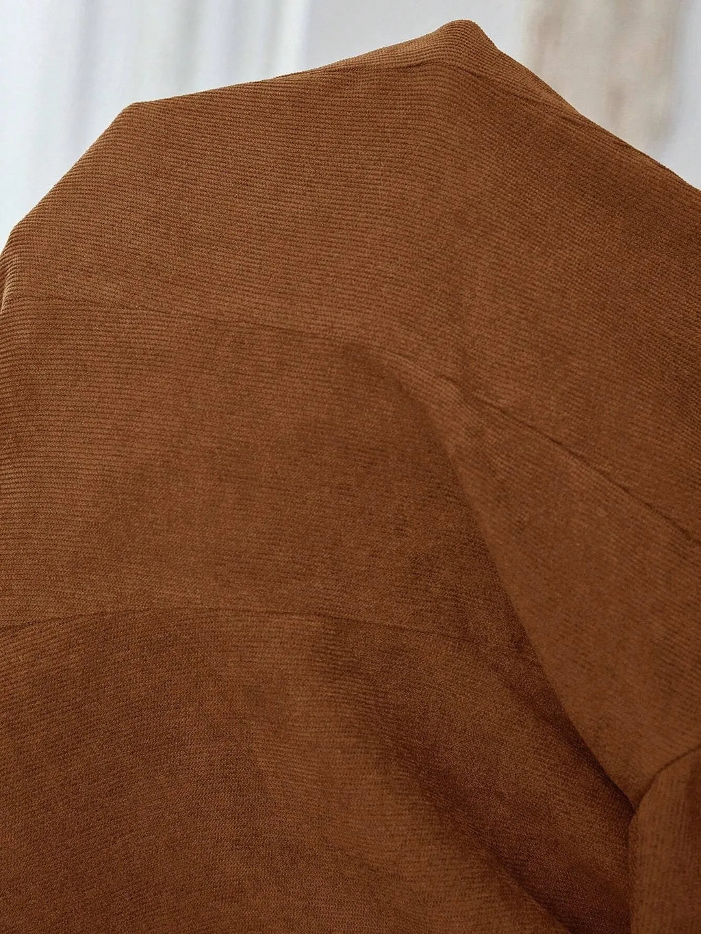 Brown single-breasted leisure suit coat with a lapel collar on a hanger.